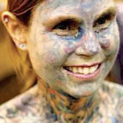 Most tattooed woman proves full body ink can be sexy in daring dress
