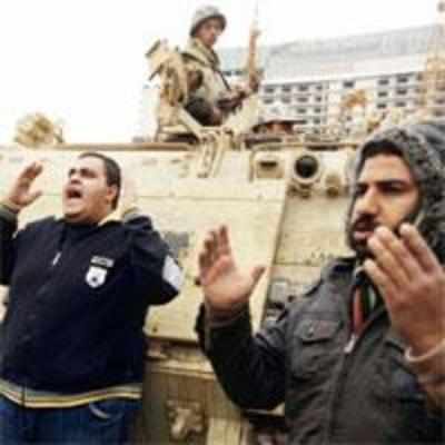 Mubarak moves to restart economy as protesters stand their ground