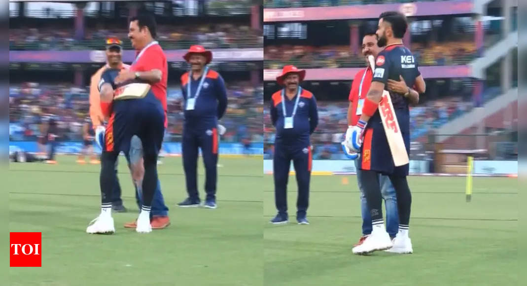 Virat Kohli: WATCH: Virat Kohli’s heartwarming gesture, touches feet of his childhood coach | Cricket News – Times of India