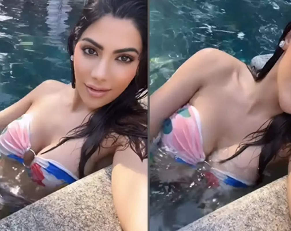 
Nikki Tamboli flaunts toned body as she takes a dip in the pool in multicoloured bikini; fan writes, 'Water is getting hot'
