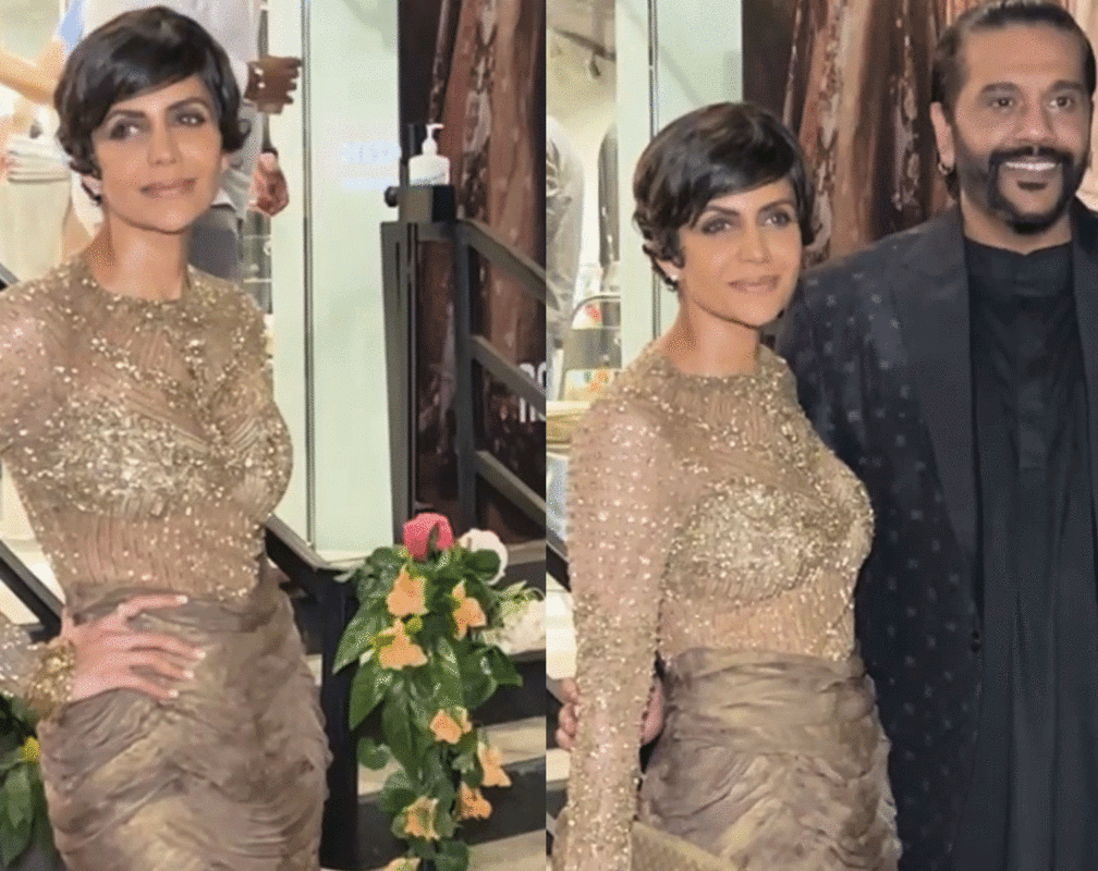 
Mandira Bedi sizzles in a shimmery mini dress, poses with designer Rocky S
