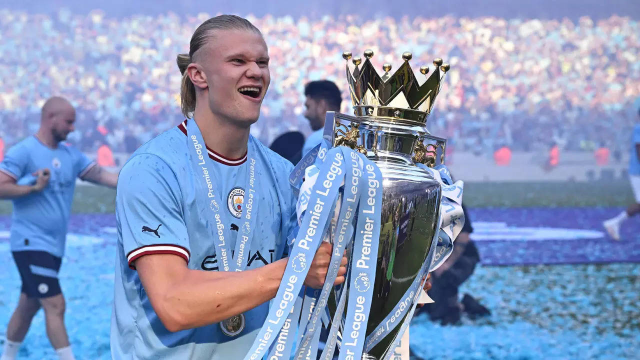 Manchester City's Erling Haaland holds the winners trophy as he celebrates  winning the English FA Cup final soccer match between Manchester City and  Manchester United at Wembley Stadium in London, Saturday, June