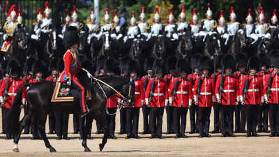 Troops feel the heat, and several faint, as Prince William reviews military parade