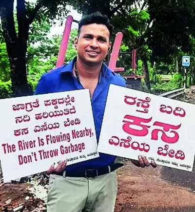 Man with placards urges public not to dump waste