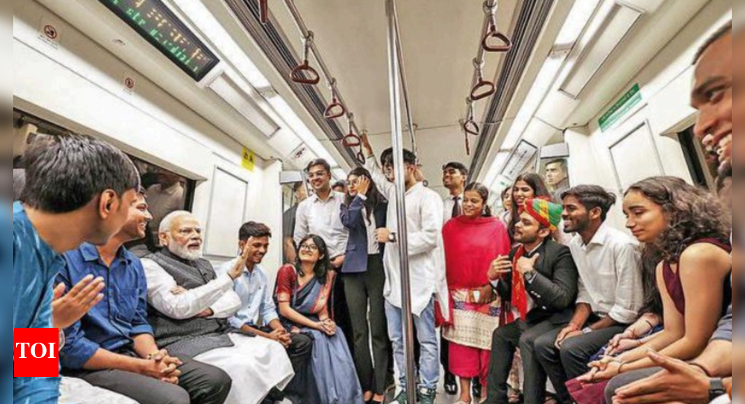 Friendly interaction: On metro ride, Modi encourages students to follow ...