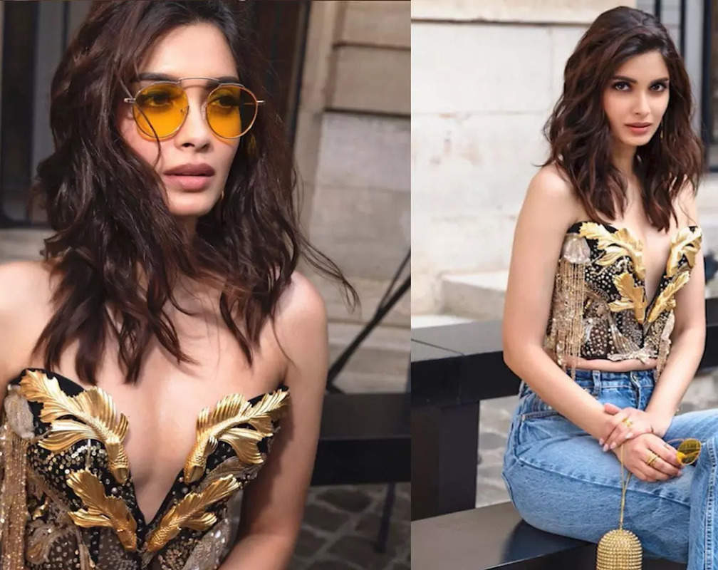
Diana Penty slays in a plunge-neck bustier and jeans at Paris Fashion Week
