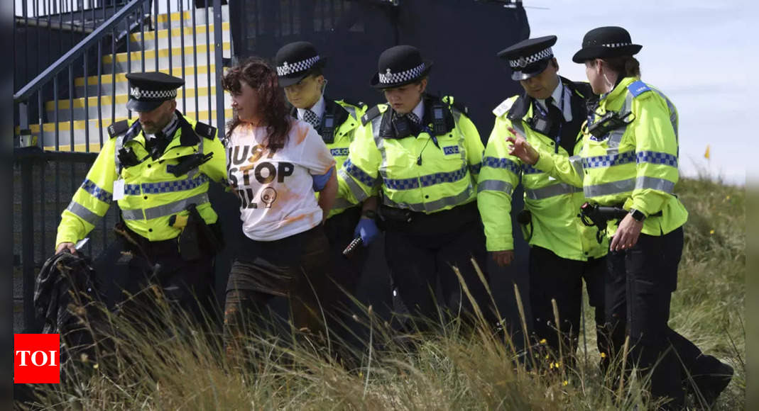 Just Stop Oil protesters set off orange flare at British Open | Golf News – Times of India
