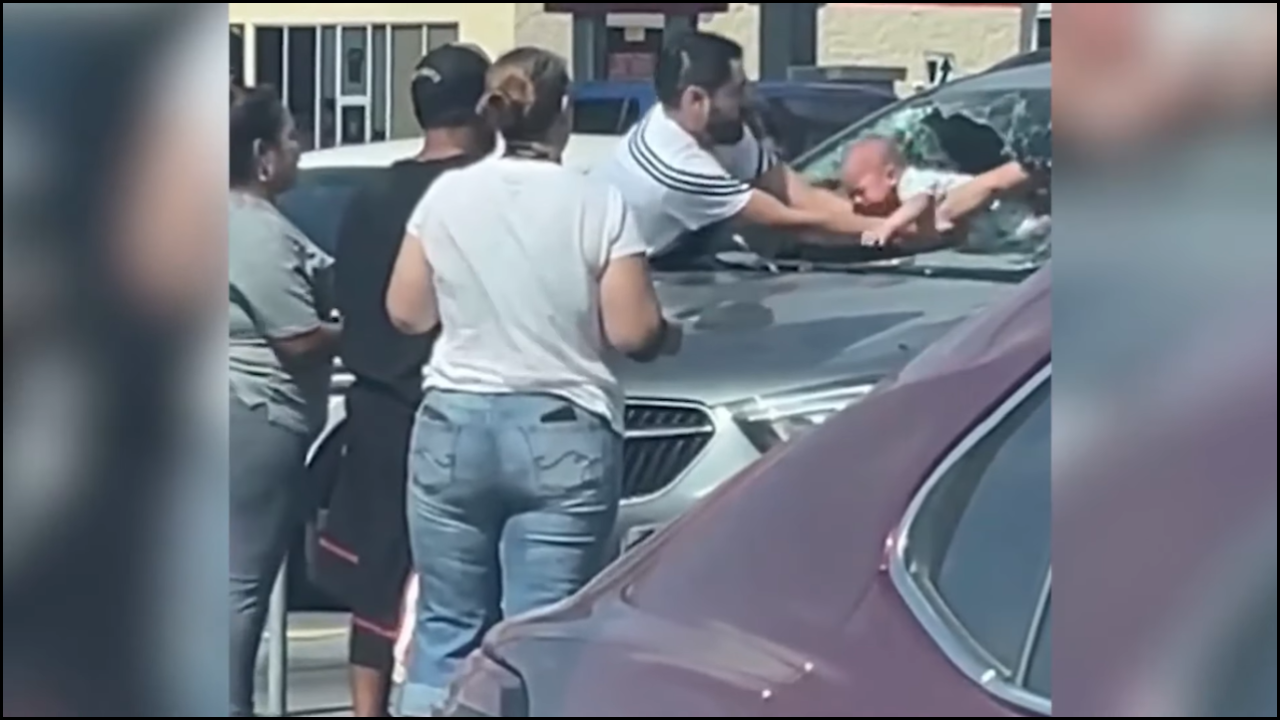 Baby being rescued from a car after the parents accidentally locked th