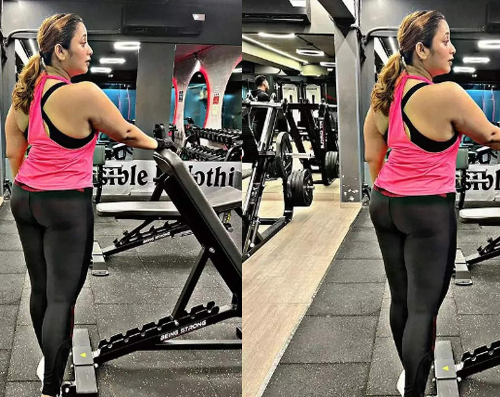 
Rani Chatterjee poses in her athleisure - pink tee and black jogger pants
