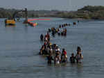 Asylum-seekers traverse Rio Grande into the US