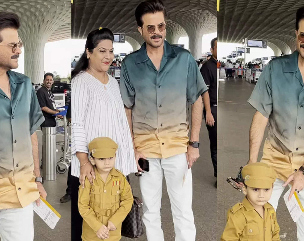 
Anil Kapoor poses with a little fan dressed as police officer at airport
