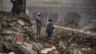 Dominican firefighters find more bodies as they fight blaze from this week's explosion; 13 killed