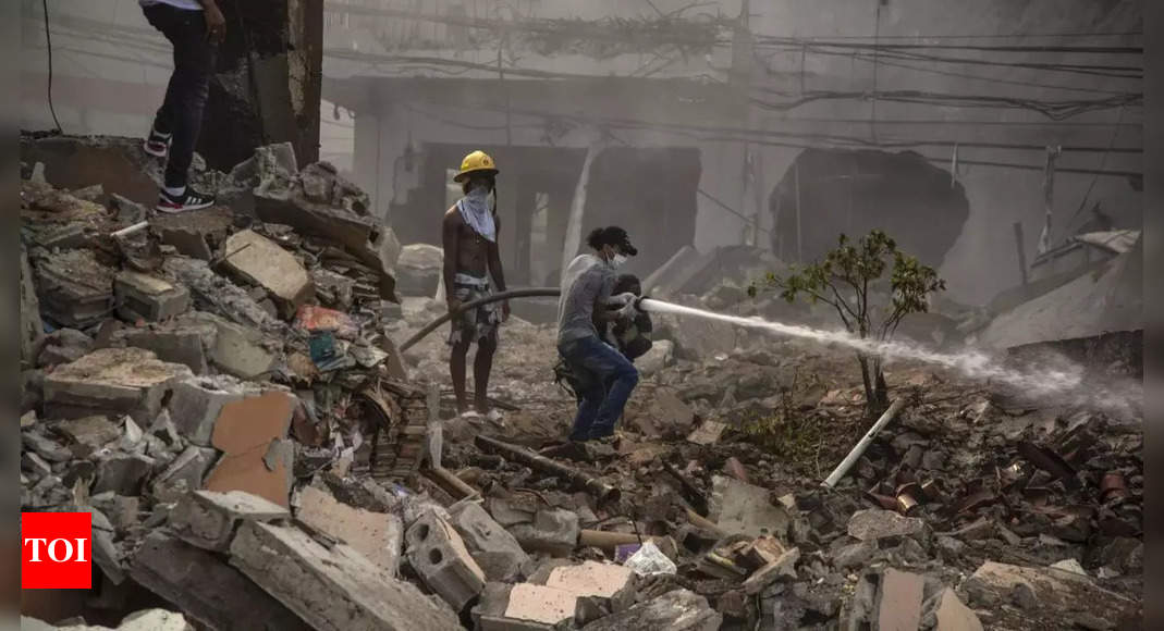 Dominican firefighters find more bodies as they fight blaze from this week’s explosion; 13 killed