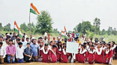 100 students sing national anthem standing in river