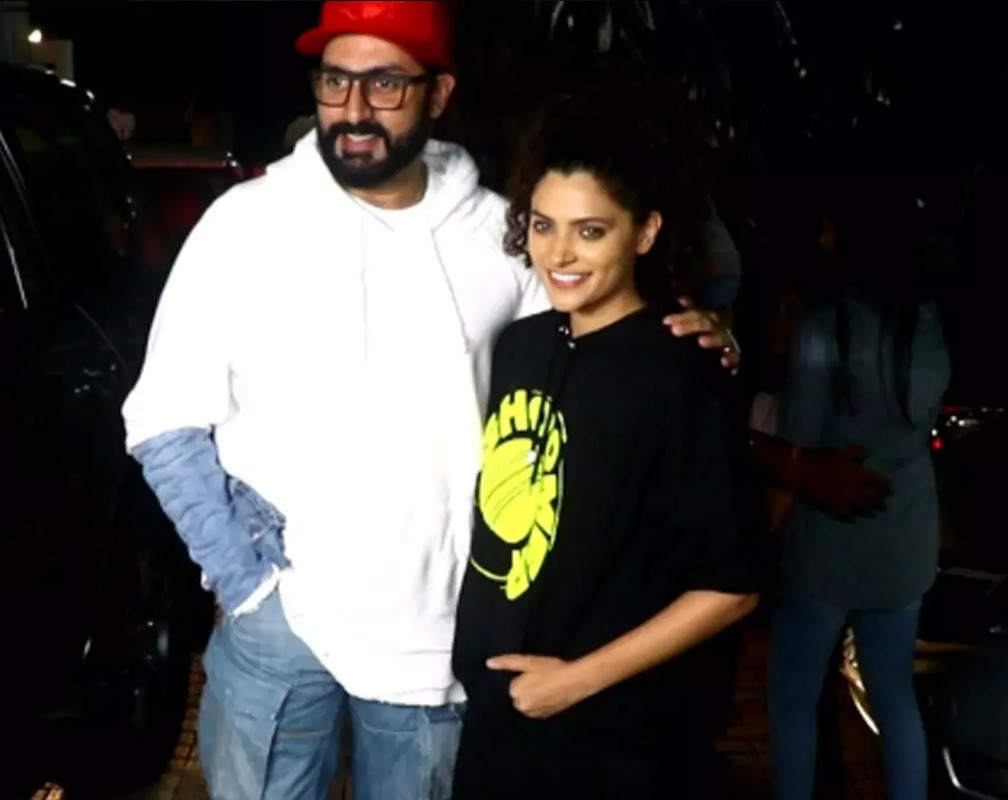 
Saiyami Kher amps up the style in black jeans and ‘Ghoomer’ logo printed black hoodie, Abhishek Bachchan keeps it quite casual with white hoodie and retro waist elastic side pockets in beige light cargo jeans
