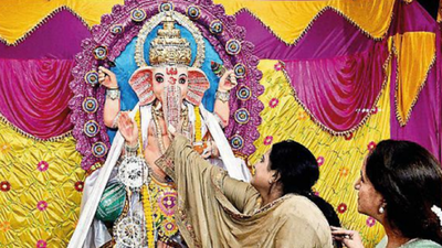 Revellers switch between work, Ganesh Puja preps