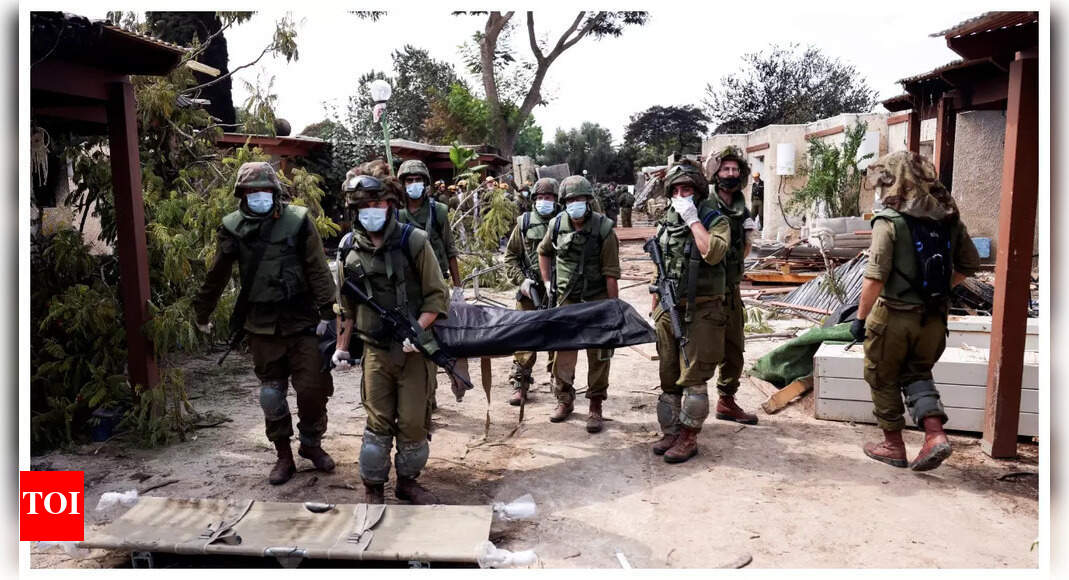 Israeli village near Gaza border lies in ruin, filled with bodies of residents & militants