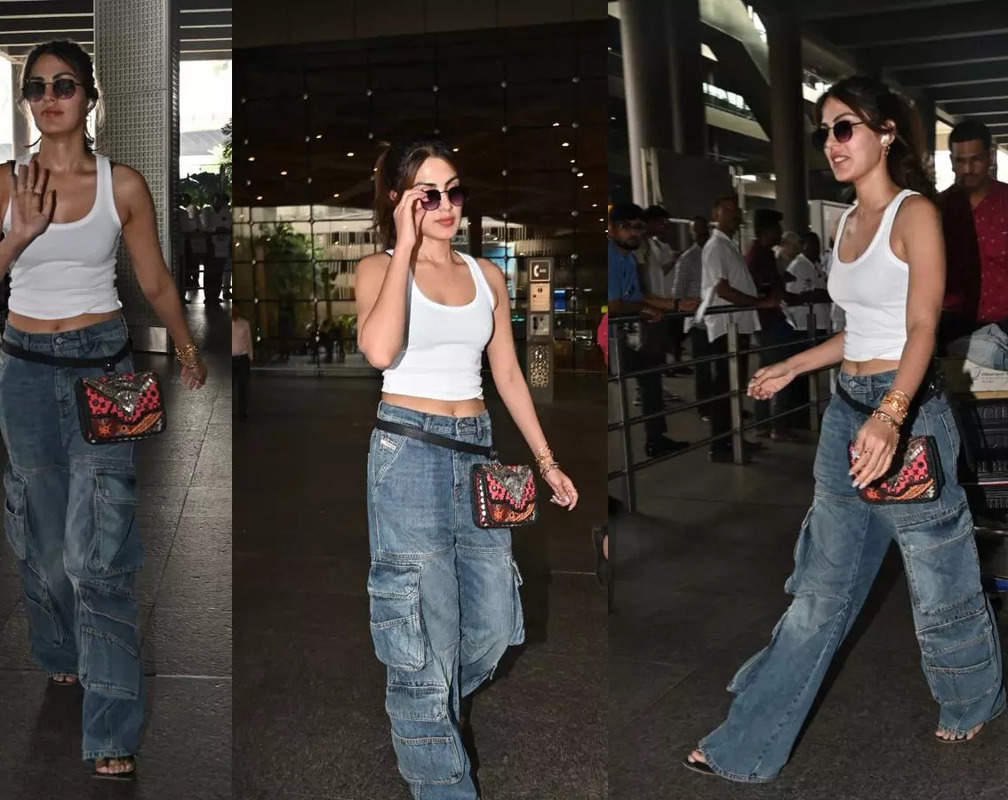 
Rhea Chakraborty takes airport fashion seriously, looks uber cool in white crop top and jeans, clicks selfies with fans
