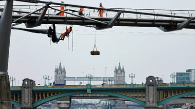 Millennium bridge: Centuries-old tradition revived, workers hang straw bales during repairs