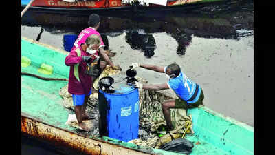 In high-tech era, fishermen use mugs to remove oil from creek