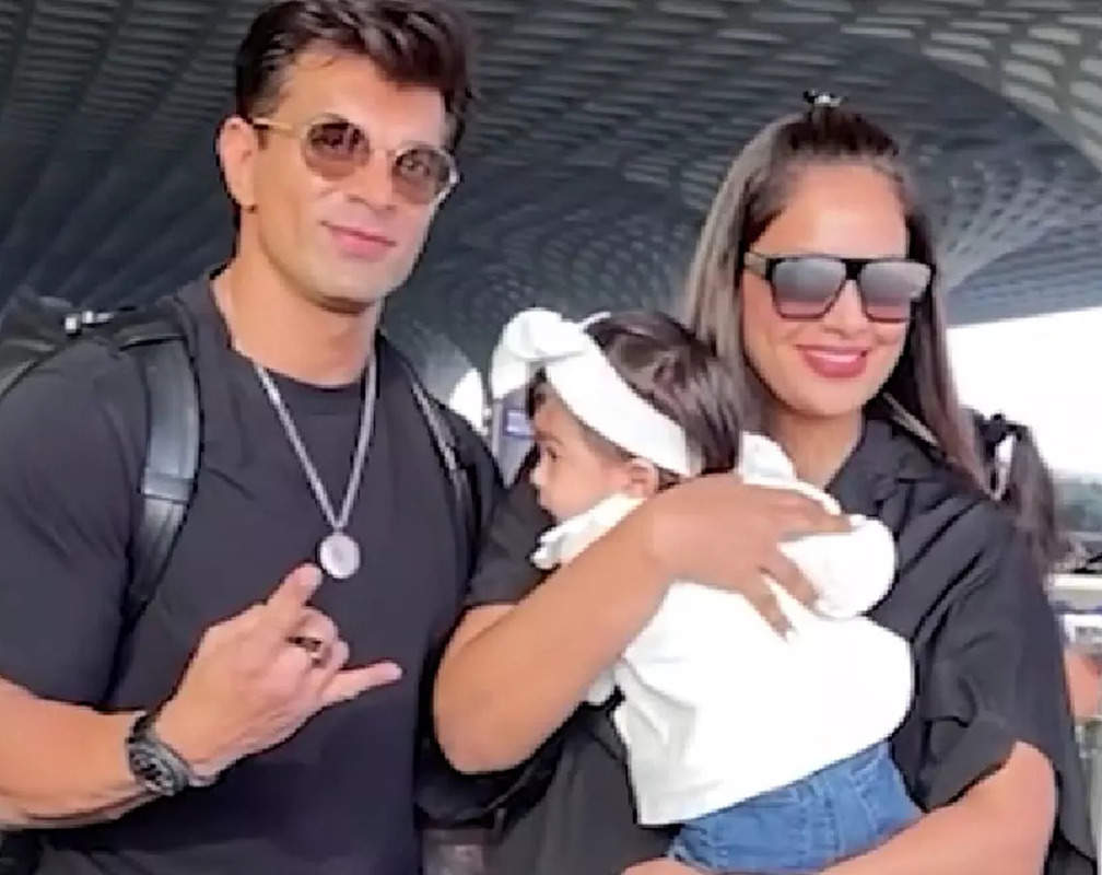 
Karan Singh Grover and Bipasha Basu twin in black as they get spotted with daughter Devi at Mumbai airport
