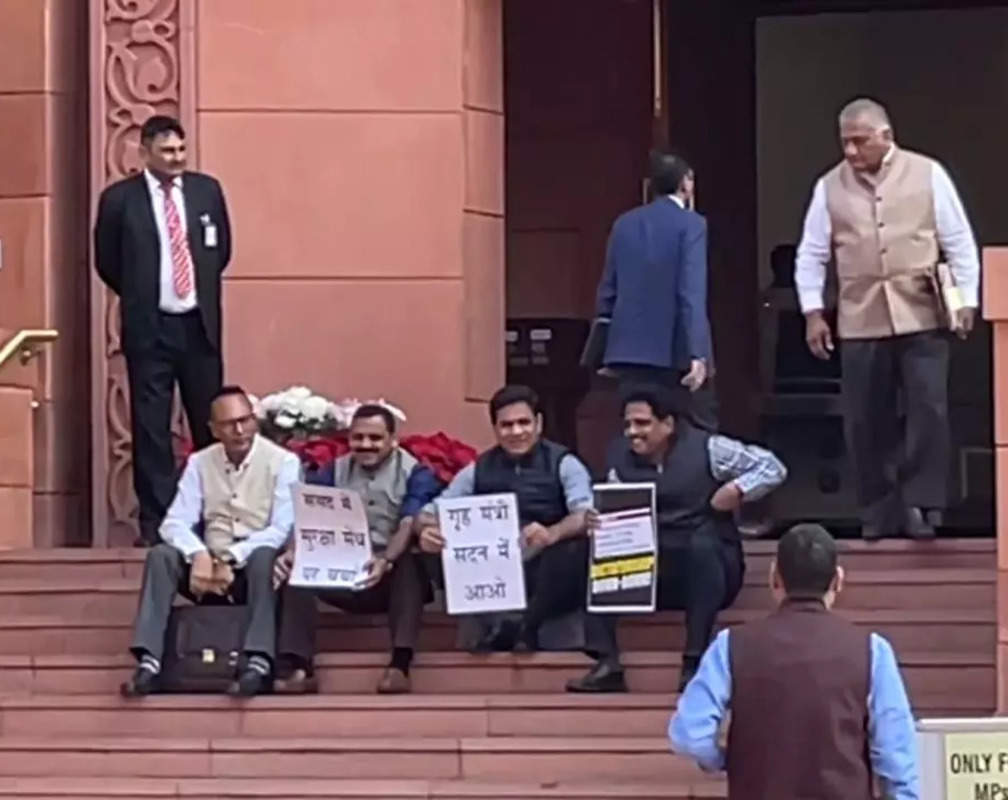 
Opposition MPs sit on the stairs of Parliament’s entrance in protest against suspension
