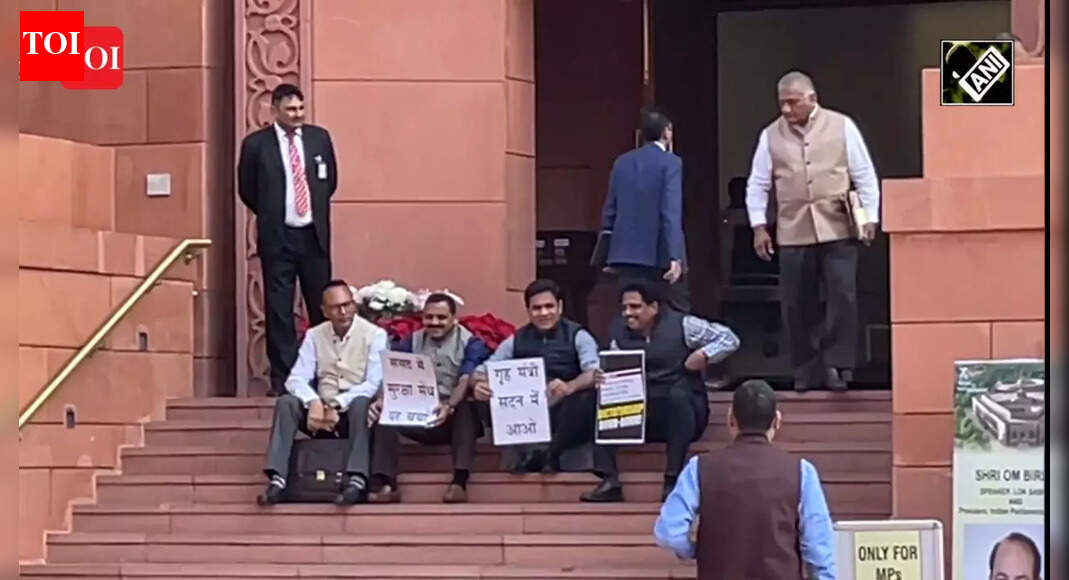 Opposition MPs sit on the stairs of Parliament’s entrance in protest ...