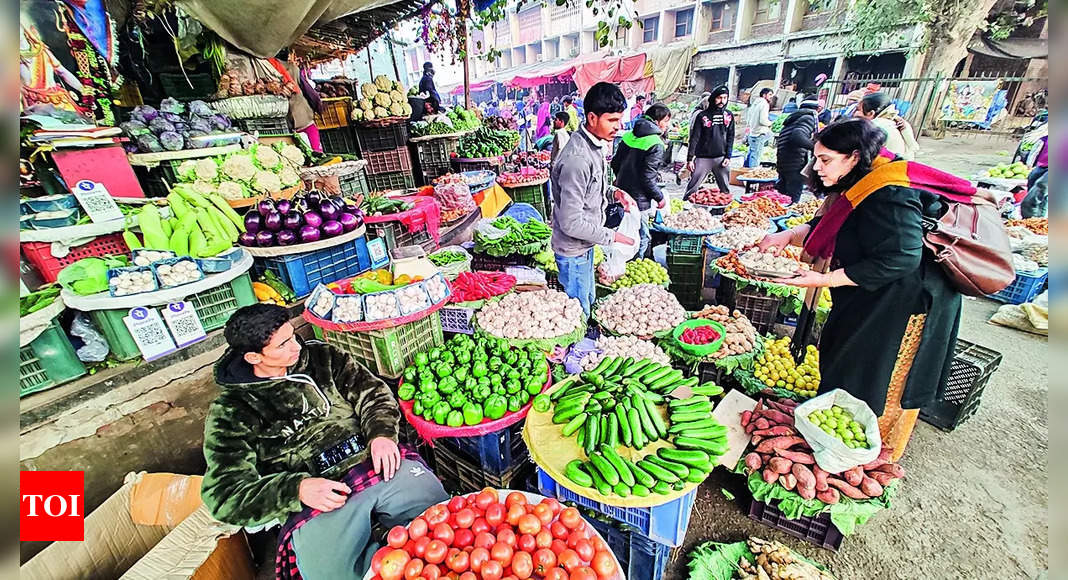 Pakistani shoppers purchase vegetables from a stall inside a