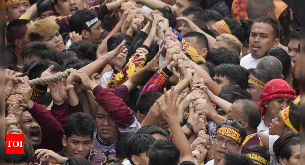 Filipino Catholics pray for Mideast peace in massive procession venerating a black statue of Jesus