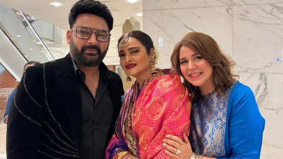 Kapil Sharma and Ginni Chatrath pose with the legendary actress Rekha at Ira Khan and Nupur Shikhare's wedding reception