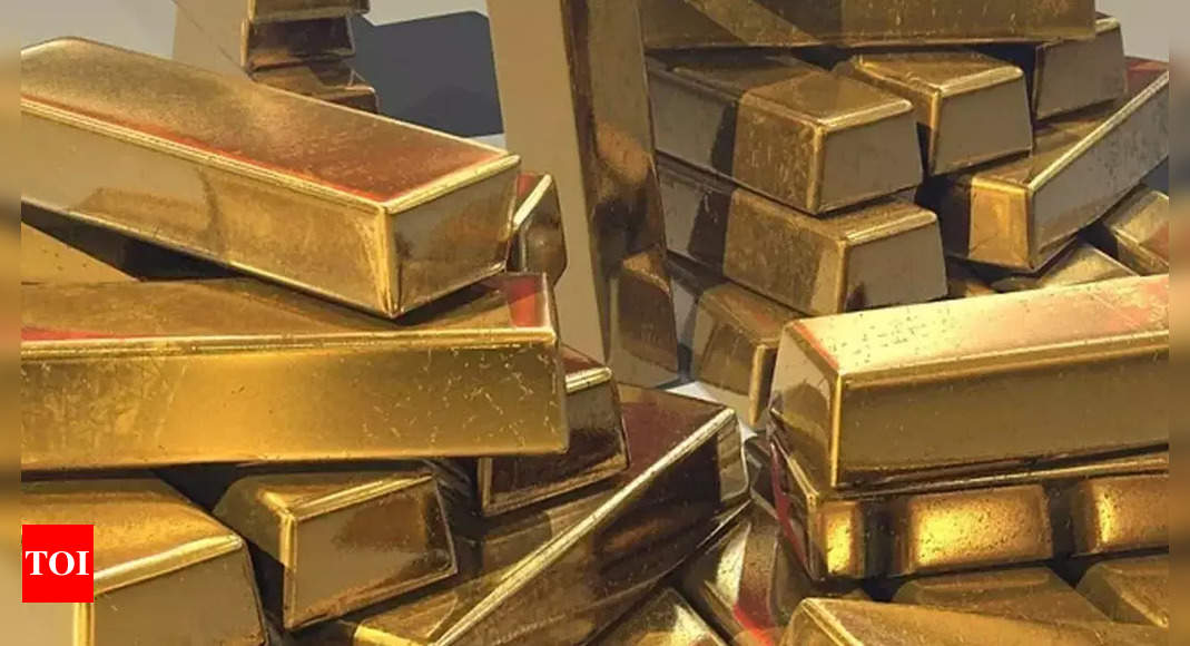 Gold prices dip as dollar strengthens; what should investors do? | India Business News – Times of India