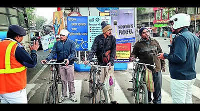 Lessons on traffic rules, reflectors, signals at road safety campaign for city cyclists
