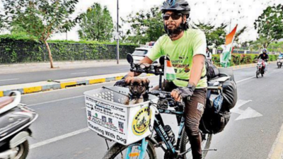 Cyclist on 42,000-km journey with his pup to 'save humanity'