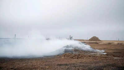 Winds threaten to fuel huge Texas wildfire as blizzard hits California