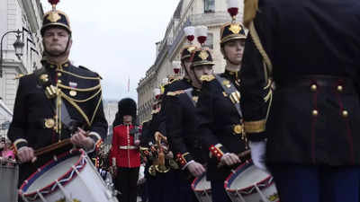 British, French troops march in historic joint parades in London and Paris in a show of solidarity