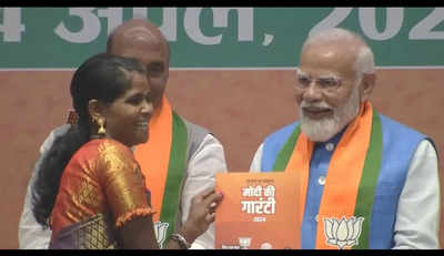 PM Narendra Modi presents manifesto to Bastar's daughter Neelavati Maurya