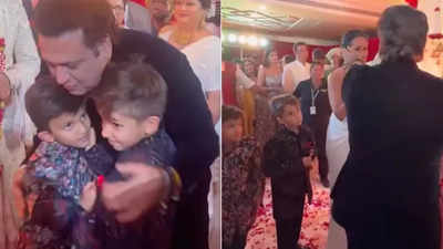 Govinda poses for a picture with Krushna Abhishek and Kashmera, hugs and kisses their kids at Arti Singh's wedding