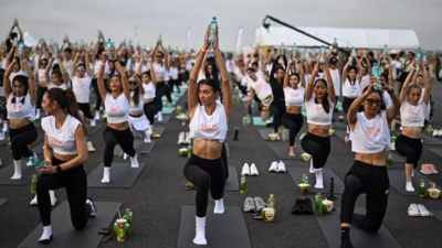 'Feel like a beautiful bird': Hundreds do yoga on Thai airport runway