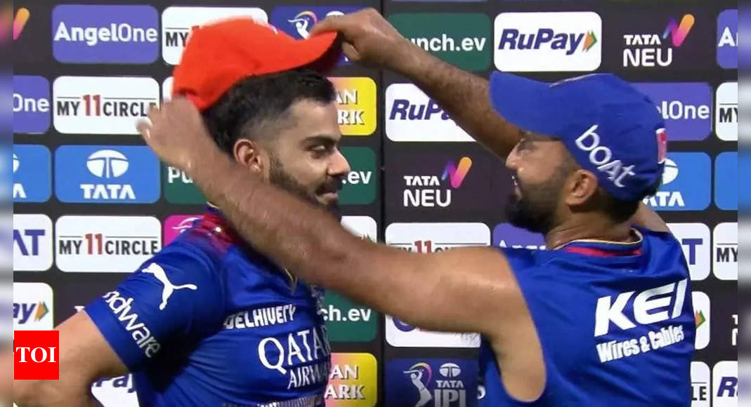 Watch: What Virat Kohli did after receiving the Orange Cap from Dinesh Karthik | Cricket News – Times of India