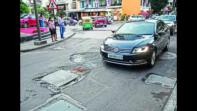 Mercedes or Porsche? No escaping potholes on this posh Bengaluru road