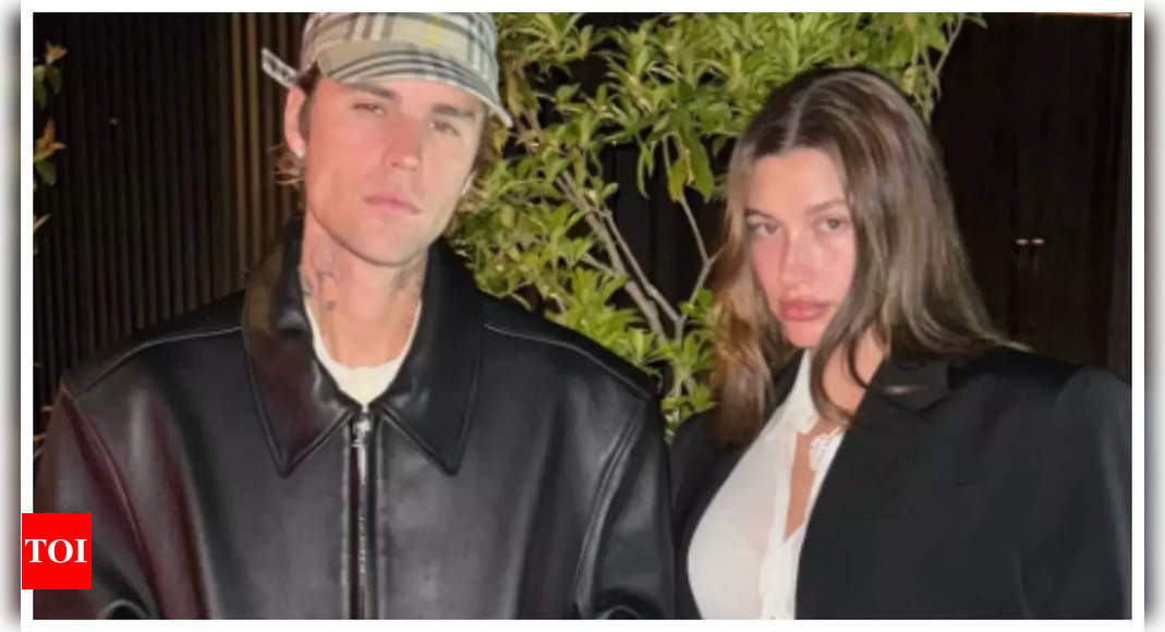 Justin Bieber cradles Hailey Bieber's baby bump as they pack on the PDA ...