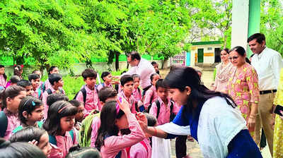 Tilak, garlands & sweets: Students back to school