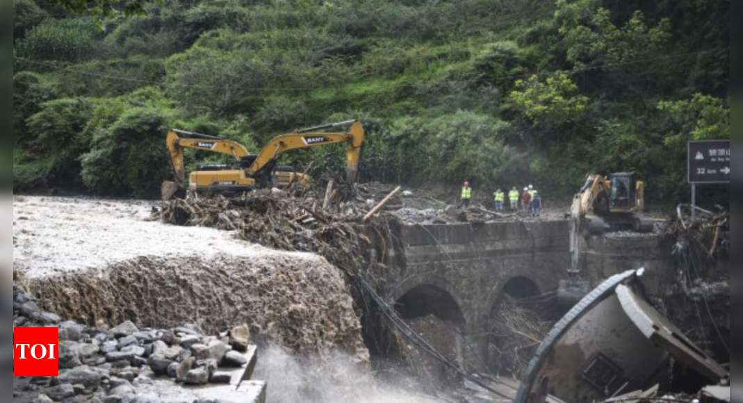 Rescuers search for dozens missing after flooding and a bridge collapse ...