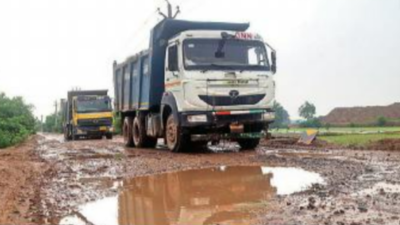 Back-breaking ride: Road filled with craters, trucks making them worse