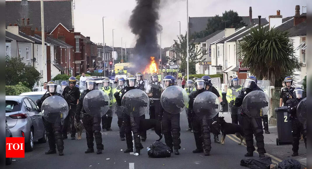 How a far-right conspiracy theory fuelled riots across the UK - Times ...