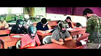 Rajasthan University students wear helmets to class as roof plaster falls