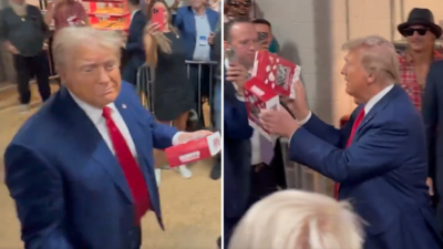 Watch: Trump throws popcorn at the stadium crowd, who chant “USA” as he enters