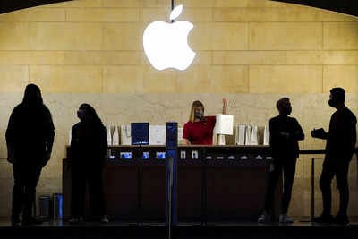 Apple employees work in an Apple Store