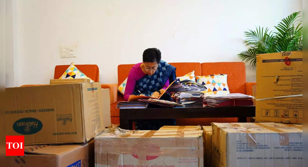 Delhi CM house row: AAP shares images of Atishi working amid packed cartons, accuses BJP of ‘forcibly capturing’ bungalow | Delhi News