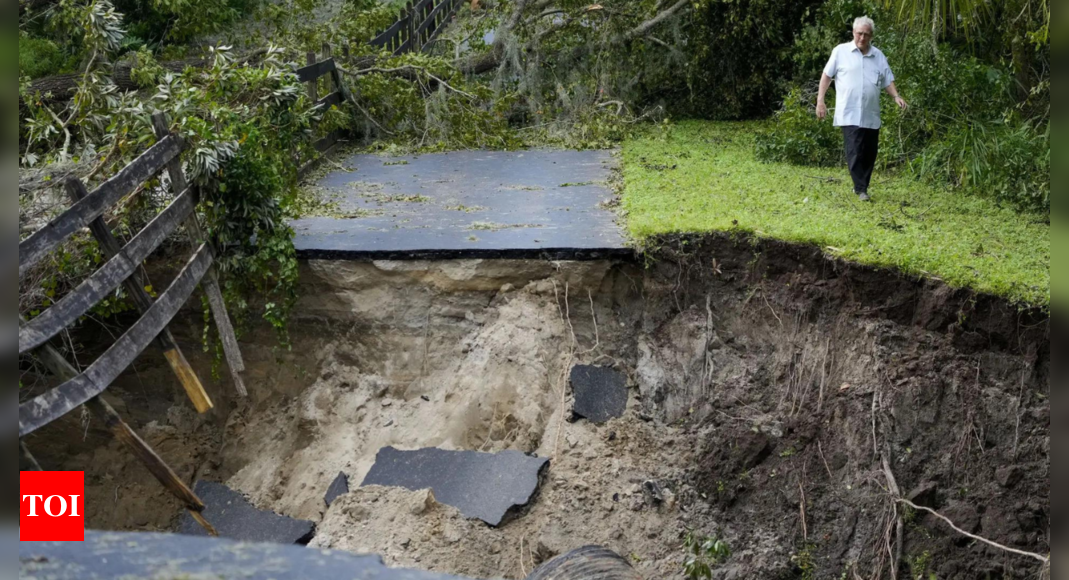 Residents slog through flooded streets, clear debris after Hurricane Milton tore through Florida – Times of India